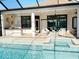 Expansive backyard with pool, spa, outdoor kitchen, and covered patio, perfect for outdoor living and entertaining at 5305 Brookgrove Dr, Sarasota, FL 34238