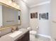 Tastefully designed bathroom with modern fixtures, a gold-framed mirror, and decorative wall art at 5305 Brookgrove Dr, Sarasota, FL 34238