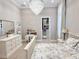 Bright bedroom featuring a chandelier, and a well-organized closet at 5305 Brookgrove Dr, Sarasota, FL 34238