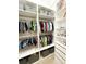 Organized walk-in closet with ample hanging space, shelving, and storage bins at 5305 Brookgrove Dr, Sarasota, FL 34238