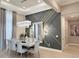 Modern dining room with a decorative wall, a stylish chandelier, and a large marble table at 5305 Brookgrove Dr, Sarasota, FL 34238