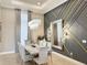 Dining room features stylish decor, a modern chandelier, a decorative wall, and a marble dining table at 5305 Brookgrove Dr, Sarasota, FL 34238