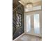 Elegant entryway features modern wall decor, double doors, and stylish lighting, creating a grand entrance at 5305 Brookgrove Dr, Sarasota, FL 34238