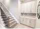 Welcoming entryway features staircase and built-in cabinets with countertop at 5305 Brookgrove Dr, Sarasota, FL 34238