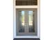 A close up of double front doors featuring unique geometric designs and brushed nickel hardware at 5305 Brookgrove Dr, Sarasota, FL 34238