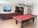 Spacious game room with a pool table, comfortable seating, and a bar area, perfect for entertaining guests at 5305 Brookgrove Dr, Sarasota, FL 34238