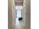 Hallway view into the main bedroom suite with modern lighting and neutral walls and flooring at 5305 Brookgrove Dr, Sarasota, FL 34238