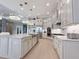 A vast kitchen with an oversized island, stainless steel appliances, and pendant lighting at 5305 Brookgrove Dr, Sarasota, FL 34238