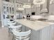 Luxury kitchen boasting marble island, stainless appliances, and custom display cabinetry at 5305 Brookgrove Dr, Sarasota, FL 34238