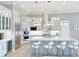 Beautiful kitchen offers stainless appliances, custom cabinetry, a bar fridge, and spacious island at 5305 Brookgrove Dr, Sarasota, FL 34238