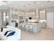 Bright, modern kitchen features a large island with seating, stainless steel appliances, and stylish pendant lighting at 5305 Brookgrove Dr, Sarasota, FL 34238