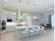 Spacious kitchen with island seating, stainless appliances, and a seamless flow to dining area at 5305 Brookgrove Dr, Sarasota, FL 34238