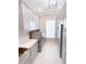 Functional laundry room with light gray cabinets, quartz countertops, and side-by-side washer and dryer units at 5305 Brookgrove Dr, Sarasota, FL 34238