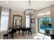 Bright living room has two pianos, large windows, and sliding glass door to backyard pool at 5305 Brookgrove Dr, Sarasota, FL 34238