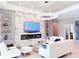 Bright living room with sleek fireplace, statement lighting, and contemporary furnishings at 5305 Brookgrove Dr, Sarasota, FL 34238