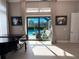 Bright living room with hardwood floors and access to a backyard pool through sliding glass doors at 5305 Brookgrove Dr, Sarasota, FL 34238