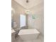 The main bathroom features a freestanding tub and stylish lighting and tile work at 5305 Brookgrove Dr, Sarasota, FL 34238