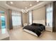 Spacious main bedroom features a modern bed, tray ceiling, and ample natural light at 5305 Brookgrove Dr, Sarasota, FL 34238