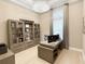 Bright office space featuring built-in bookcases, modern desk, and a large window for natural light at 5305 Brookgrove Dr, Sarasota, FL 34238