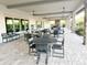 Covered patio with tables and chairs offering a relaxing outdoor space for dining and socializing at 5305 Brookgrove Dr, Sarasota, FL 34238