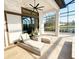 Serene outdoor patio with lounge chairs, ceiling fan, and tranquil views of the surrounding landscape at 5305 Brookgrove Dr, Sarasota, FL 34238