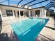 Stunning pool with spa surrounded by travertine deck, covered lanai, and a screened enclosure for year-round enjoyment at 5305 Brookgrove Dr, Sarasota, FL 34238