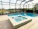 Screened-in pool and spa overlook a serene lake with beautiful landscaping at 5305 Brookgrove Dr, Sarasota, FL 34238