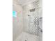 Modern shower with decorative tile, a rainfall shower head and niche shelving at 5305 Brookgrove Dr, Sarasota, FL 34238