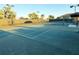 Outdoor tennis court with well-maintained green surface and net at 5305 Brookgrove Dr, Sarasota, FL 34238