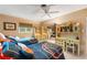 Twin bedroom with ceiling fan and decorative shelving and desk at 5376 Shadow Lawn Dr, Sarasota, FL 34242
