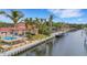 Exterior view of home featuring a large waterfront backyard and private boat dock at 5376 Shadow Lawn Dr, Sarasota, FL 34242