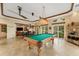 Bright game room with a billiard table, chandelier, and tile floor at 5376 Shadow Lawn Dr, Sarasota, FL 34242