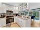 Bright kitchen with granite counters, stainless appliances, and a view of the backyard at 5376 Shadow Lawn Dr, Sarasota, FL 34242
