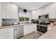 Well-lit kitchen boasts stainless steel appliances, a window view, and neutral countertops at 5376 Shadow Lawn Dr, Sarasota, FL 34242