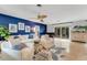 Stylish living room featuring a modern design, blue accent wall and piano at 5376 Shadow Lawn Dr, Sarasota, FL 34242