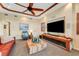 Comfortable living room featuring a large screen tv, sofa and beamed ceilings at 5376 Shadow Lawn Dr, Sarasota, FL 34242