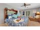 Inviting main bedroom featuring a wooden headboard, plush bedding, and serene view at 5376 Shadow Lawn Dr, Sarasota, FL 34242