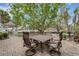 Outdoor dining area with a table, chairs, and view of the lush backyard and waterfront at 5402 Shadow Lawn Dr, Sarasota, FL 34242