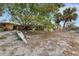 Spacious backyard featuring mature trees, a boat, and ample room for outdoor activities at 5402 Shadow Lawn Dr, Sarasota, FL 34242