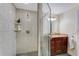 Modern bathroom features a glass-enclosed shower, granite vanity, and ceramic tile at 5402 Shadow Lawn Dr, Sarasota, FL 34242
