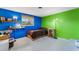 Unique bedroom with bright blue and green walls with a window offering natural light at 5402 Shadow Lawn Dr, Sarasota, FL 34242