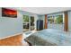 Serene bedroom offers a relaxing view of the patio and backyard through sliding glass doors at 5402 Shadow Lawn Dr, Sarasota, FL 34242