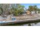 Charming single-Gathering home exterior with a gazebo, dock, and beautifully landscaped yard at 5402 Shadow Lawn Dr, Sarasota, FL 34242