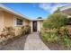 Front entrance featuring a brick pathway and well-maintained landscaping that leads to the front door at 5402 Shadow Lawn Dr, Sarasota, FL 34242