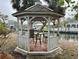 Cozy gazebo with a table and chairs overlooking the waterfront, a perfect spot for relaxation at 5402 Shadow Lawn Dr, Sarasota, FL 34242