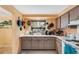 Functional kitchen features ample counter space, hanging pot rack, and window view at 5402 Shadow Lawn Dr, Sarasota, FL 34242
