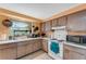 Well-lit kitchen with a sink overlooking the backyard, plenty of counter space, and essential appliances at 5402 Shadow Lawn Dr, Sarasota, FL 34242
