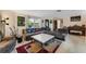 Inviting living room with plush sectional, unique coffee table, piano, and stylish decor create a cozy atmosphere at 5402 Shadow Lawn Dr, Sarasota, FL 34242
