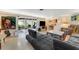 Spacious living room featuring a sectional sofa, sliding glass doors, and views to the outside at 5402 Shadow Lawn Dr, Sarasota, FL 34242