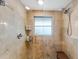 Modern shower with beige tiling, dual shower heads, and a built-in bench at 5402 Shadow Lawn Dr, Sarasota, FL 34242